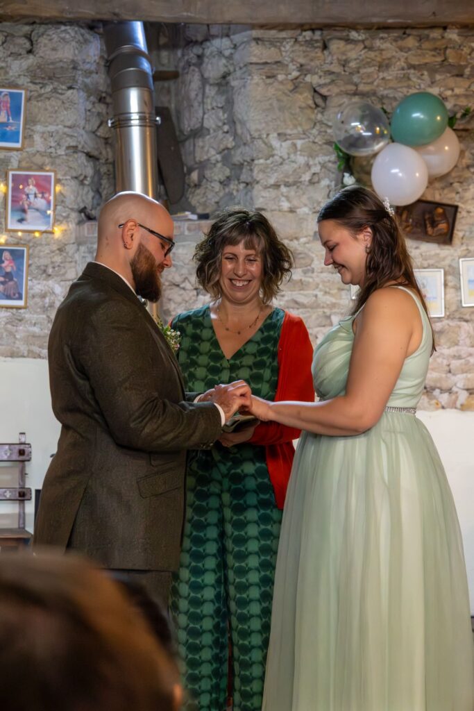 Ash Rhone Photography Amy Lee smiles at the couple do their ring exchange